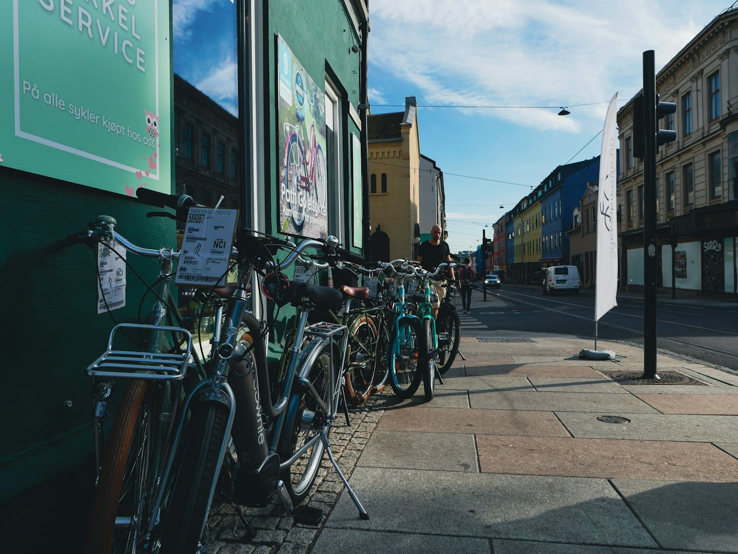 Bicycles parked outside a bike shop on a city street.